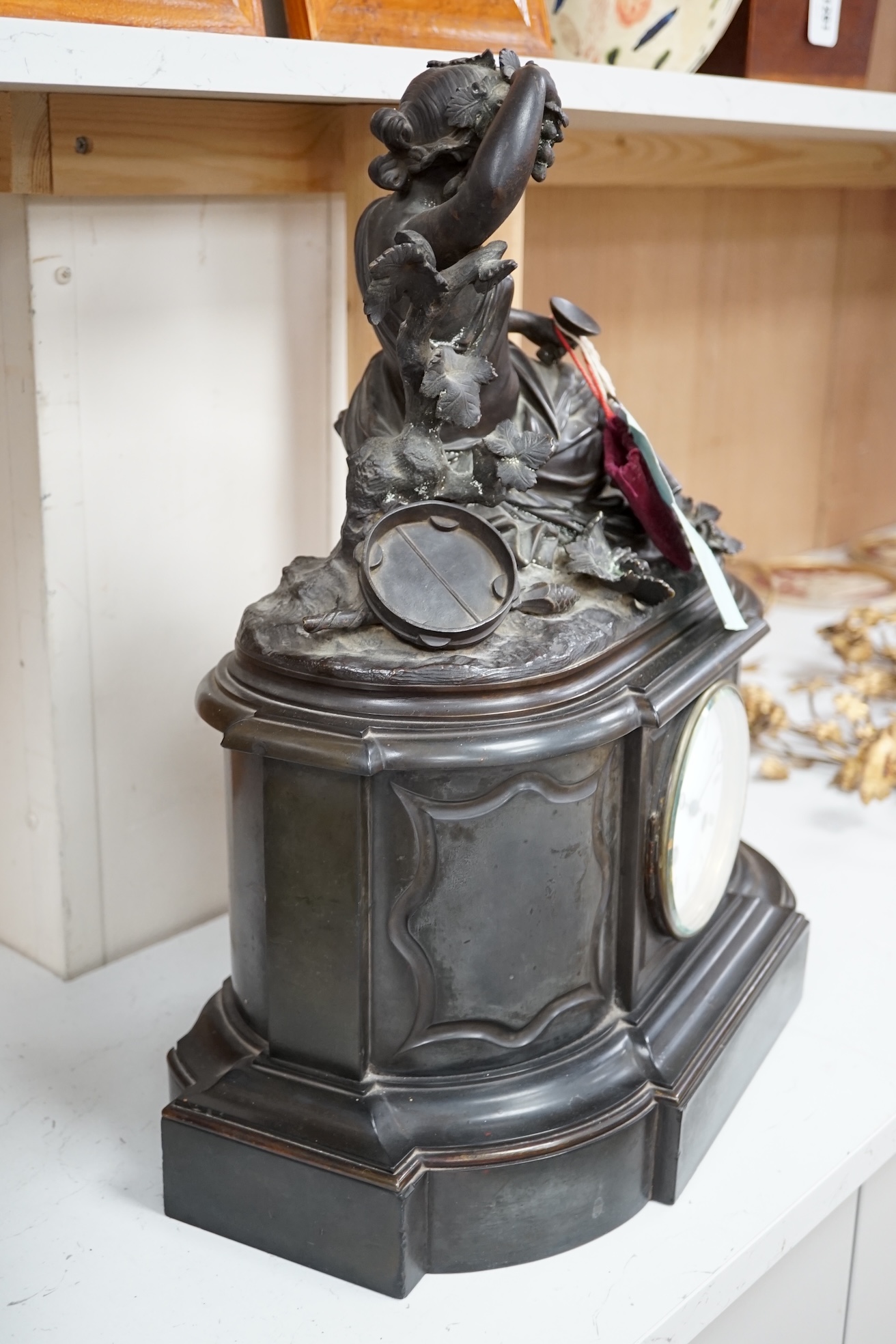 A Victorian black marble eight day mantel clock, surmounted by a cast bronze figure of a muse, with key, 48cm high. Condition - fair, untested